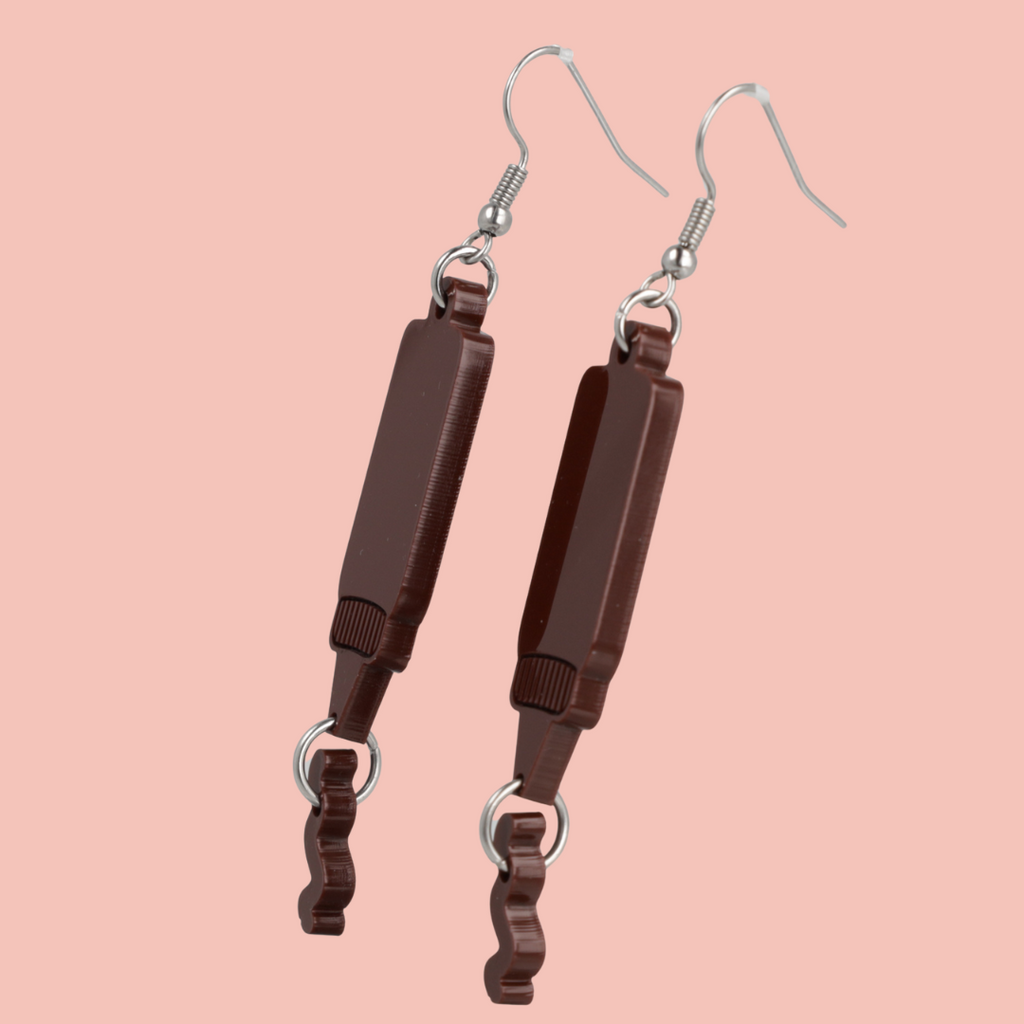 Stainless steel earwires featuring barbecue sauce acrylic charms with a charm joined to the bottle showing sauce coming out of it