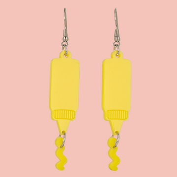 Stainless steel earwires featuring mustard acrylic charms with a charm joined to the bottle showing sauce coming out of it