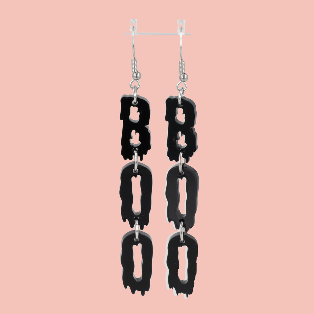 THE LETTERS B, O, O SPELLED OUT VERTICALLY WITH A BLACK DRIPPY EFFECT ON STAINLESS STEEL EARWIRES