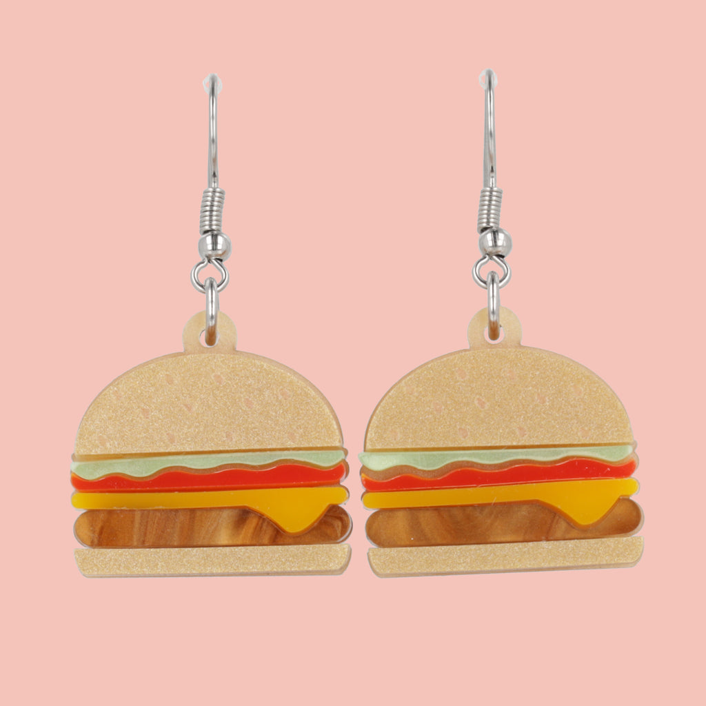 Cheeseburger acrylic charms featuring a beige bun and brown marble patty with lettuce and tomato with stainless steel earwires