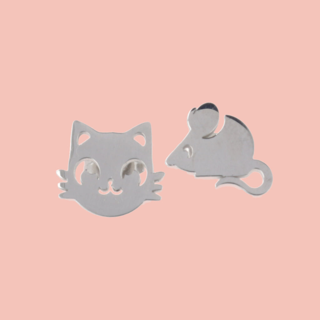 Stainless steel studs, one in the shape of a cat's face and one in the shape of a mouse