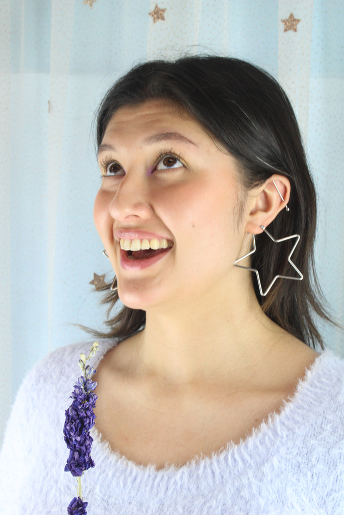 Model wearing Star shaped stainless steel hoops