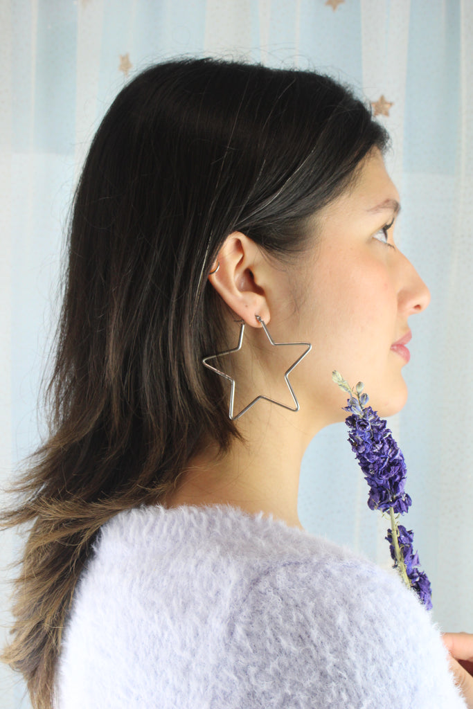 Model wearing Star shaped stainless steel hoops