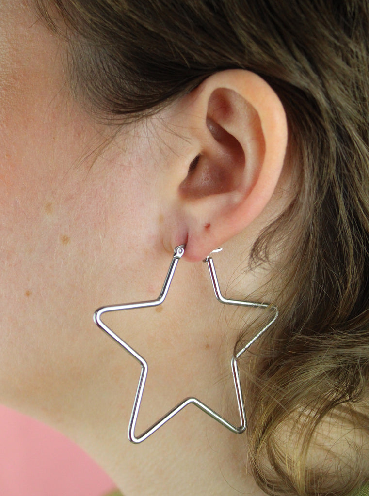 Model wearing Star shaped stainless steel hoops