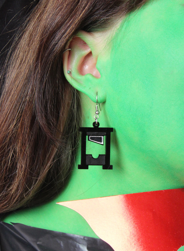 Model wearing Black guillotine charms on stainless steel earwires