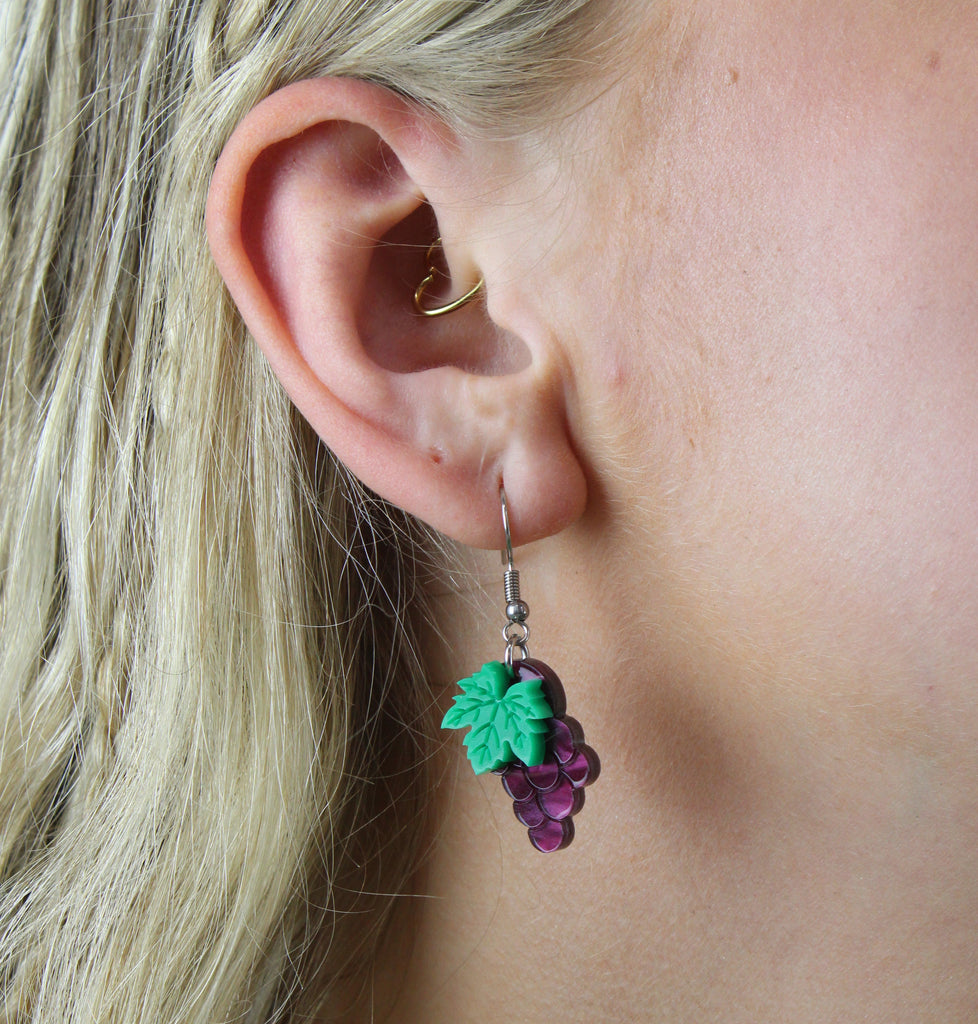 Model wearing Purple marble acrylic grape charms on stainless steel earwires