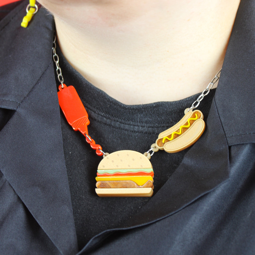 Model wearing Stainless steel oval link chain with a kethup, cheeseburger and mustard hot dog pendant