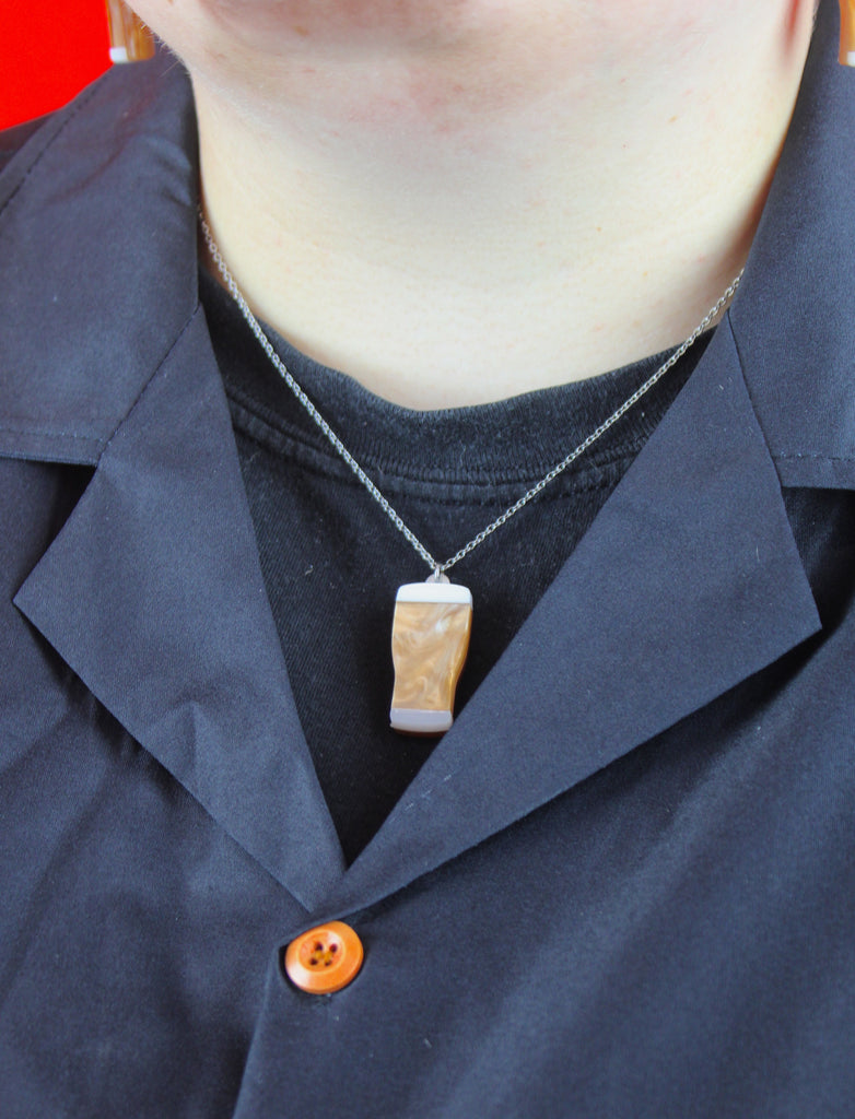 Model wearing necklace with brown acrylic marble beer pendant