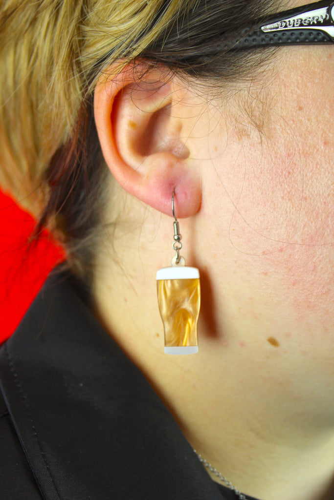 Model wearing acrylic marble beer charms on stainless steel earwires