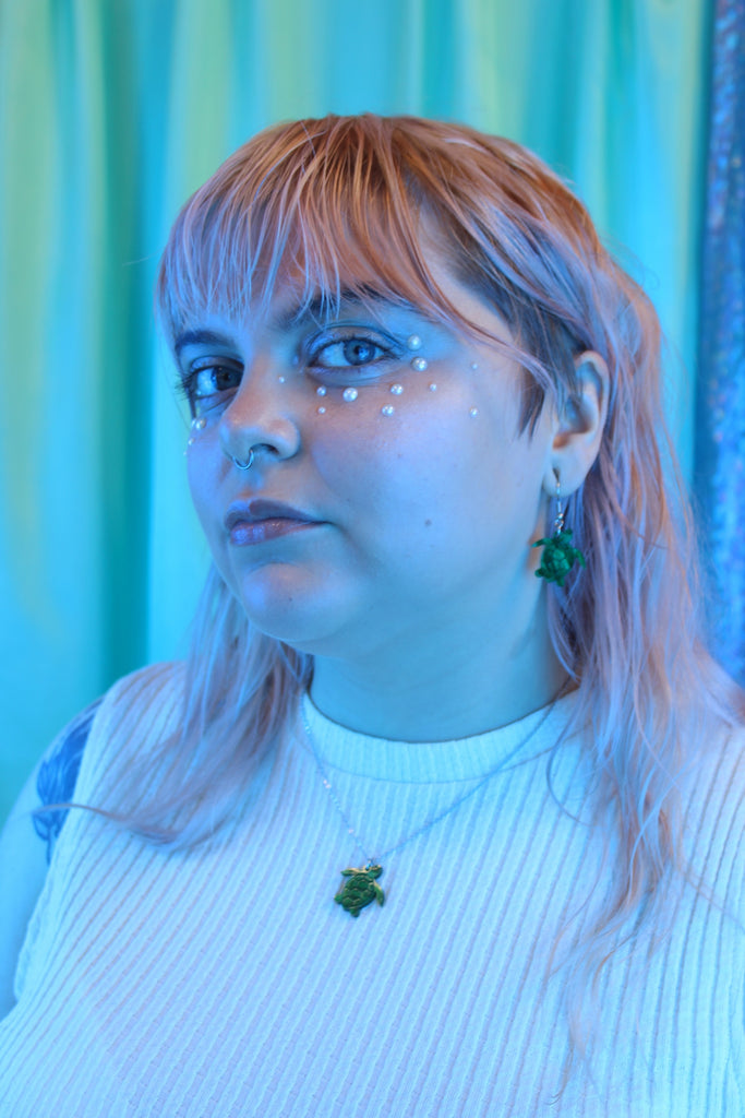 Model wearing Green marble turtle pendant on a stainless steel chain