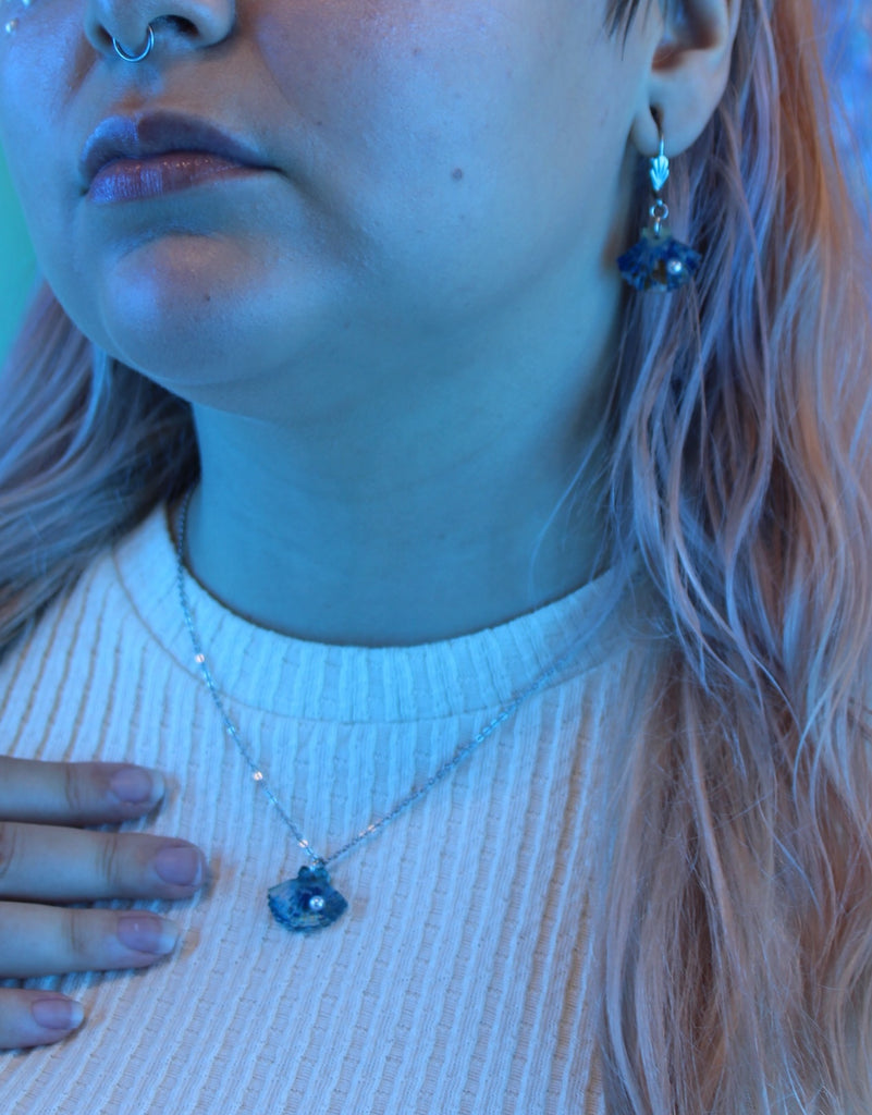 Model wearing Blue abalone shell pendant with a pearl on a stainless steel chain