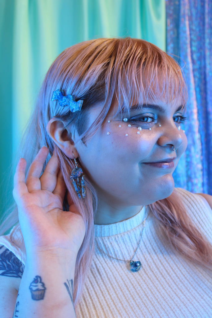 Model wearing Blue abalone jellyfish charms on stainless steel earwires