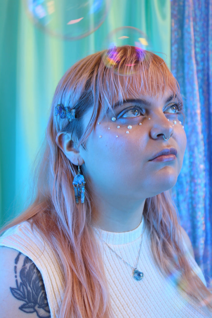 Model wearing Blue abalone jellyfish charms on stainless steel earwires