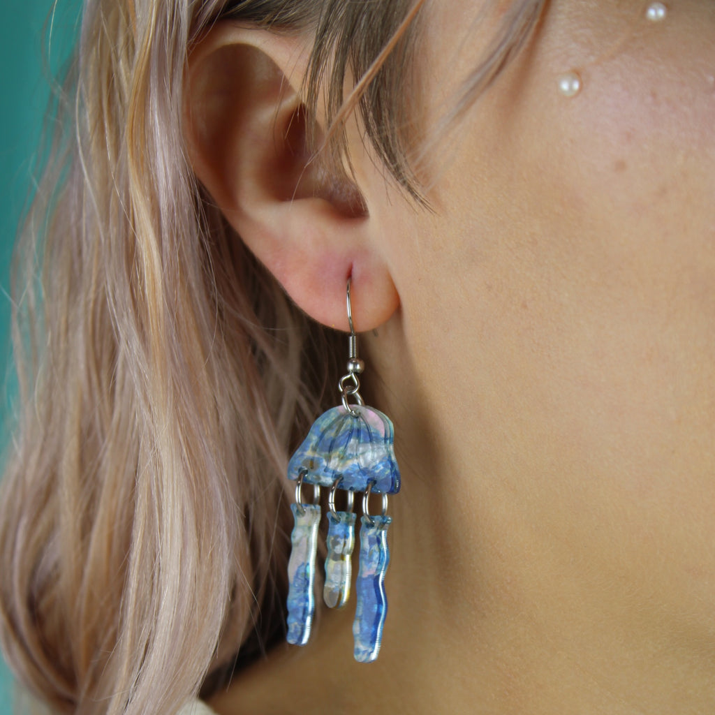 Model wearing Blue abalone jellyfish charms on stainless steel earwires