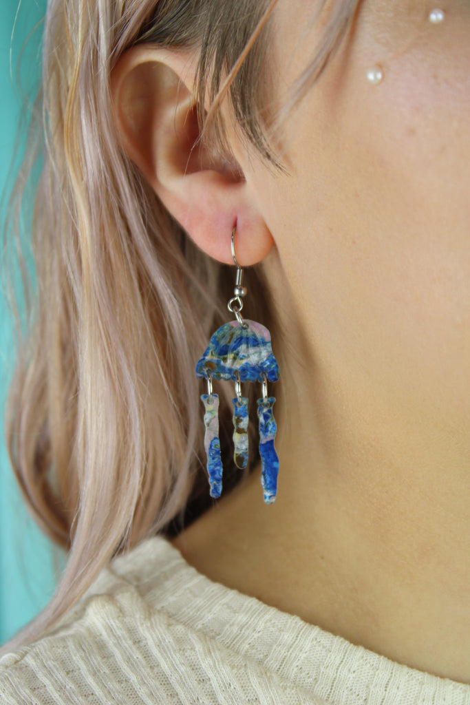 Model wearing Blue abalone jellyfish charms on stainless steel earwires