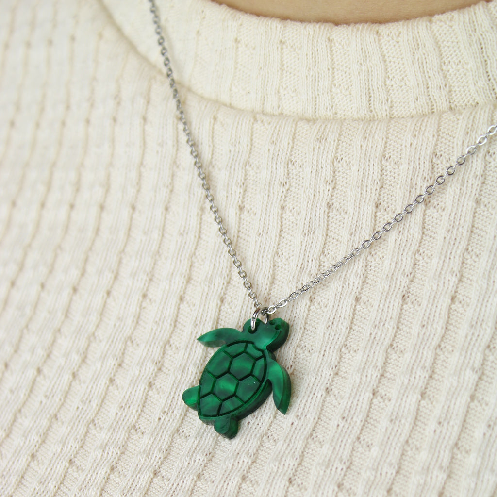 Model wearing Green marble turtle pendant on a stainless steel chain