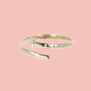 Gold plated stainless steel ring in the shape of a nail with a loop dee loop design