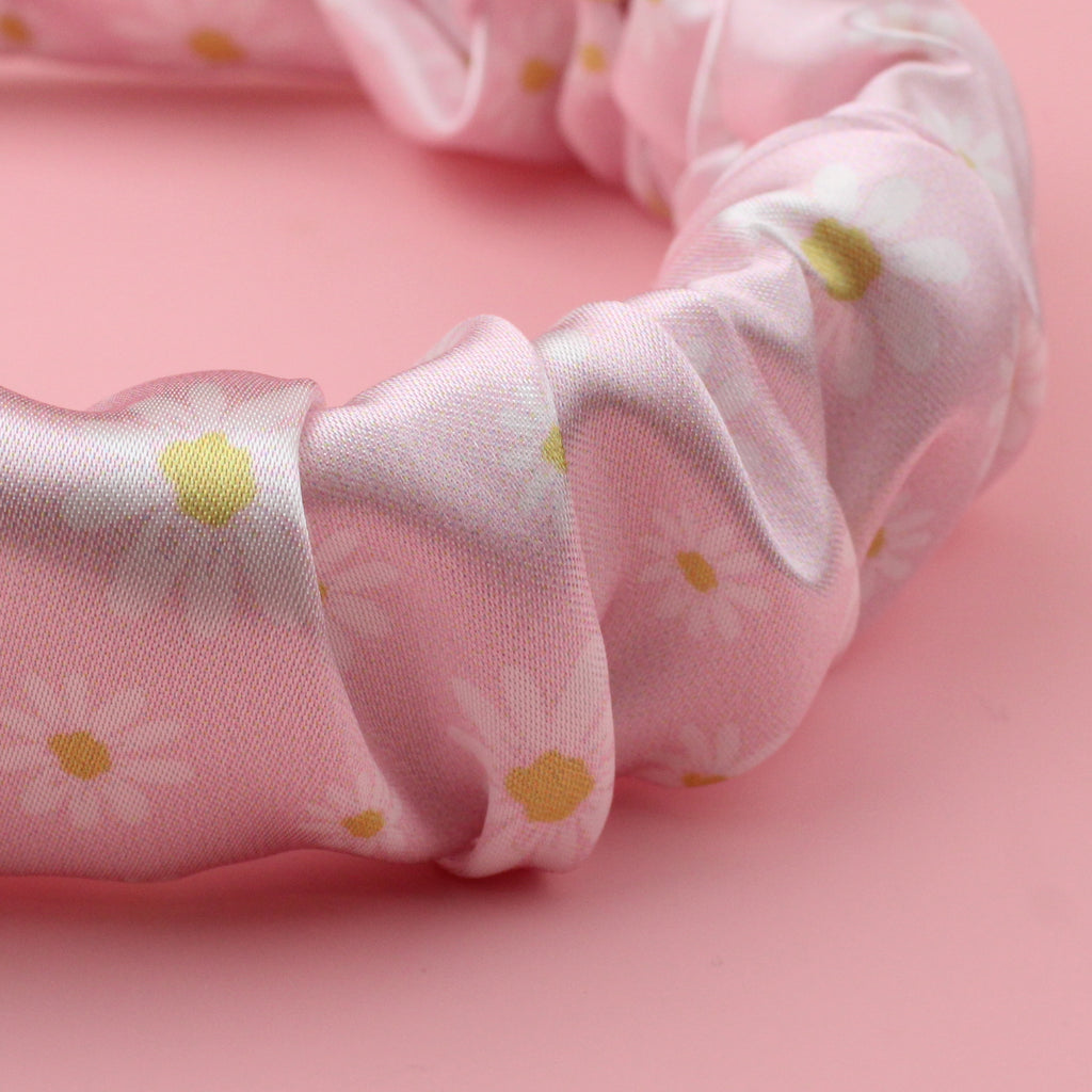 Pastel pink scrunchie style headband with a daisy design