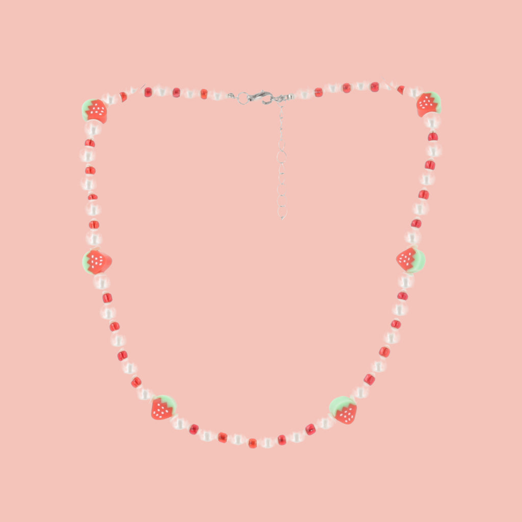 Faux pearl necklace featuring red beads and strawberry charms with a base metal clasp