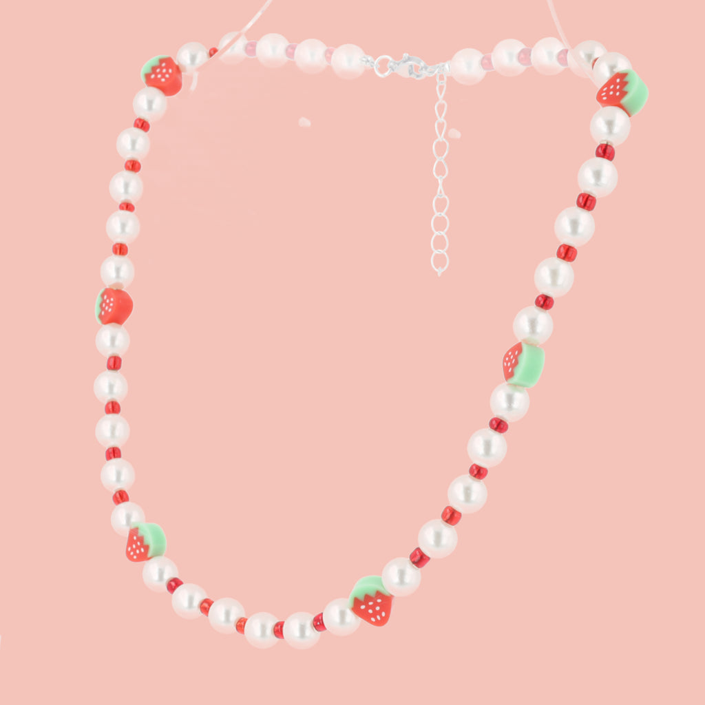 Faux pearl necklace featuring red beads and strawberry charms with a base metal clasp