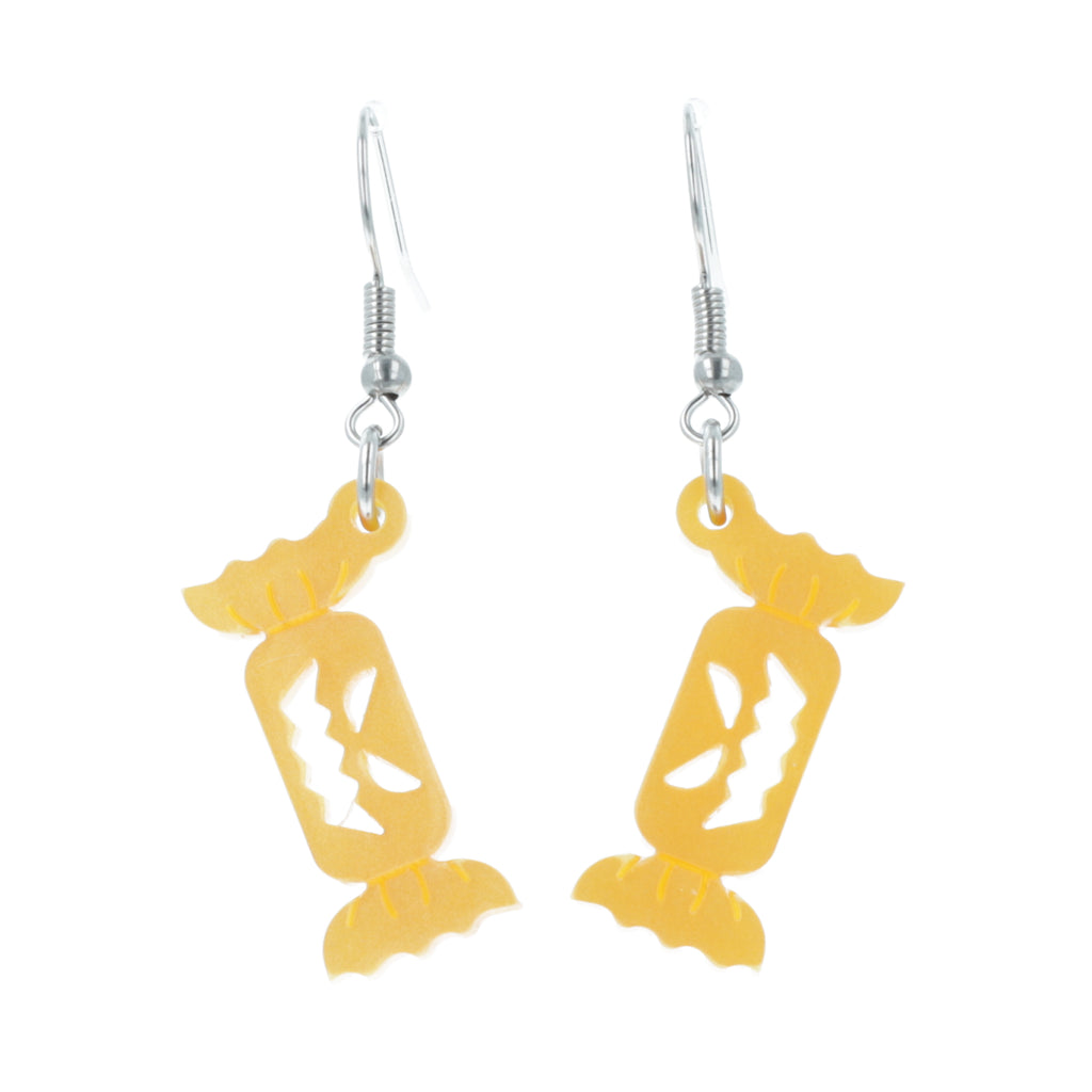 Orange sweet wrapper charms with carved faces on stainless steel earwires