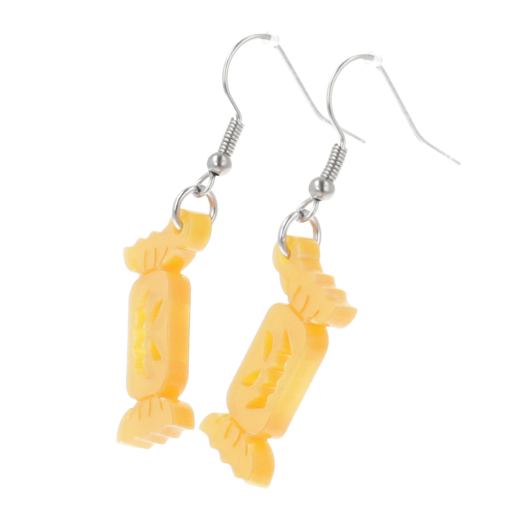 Orange sweet wrapper charms with carved faces on stainless steel earwires