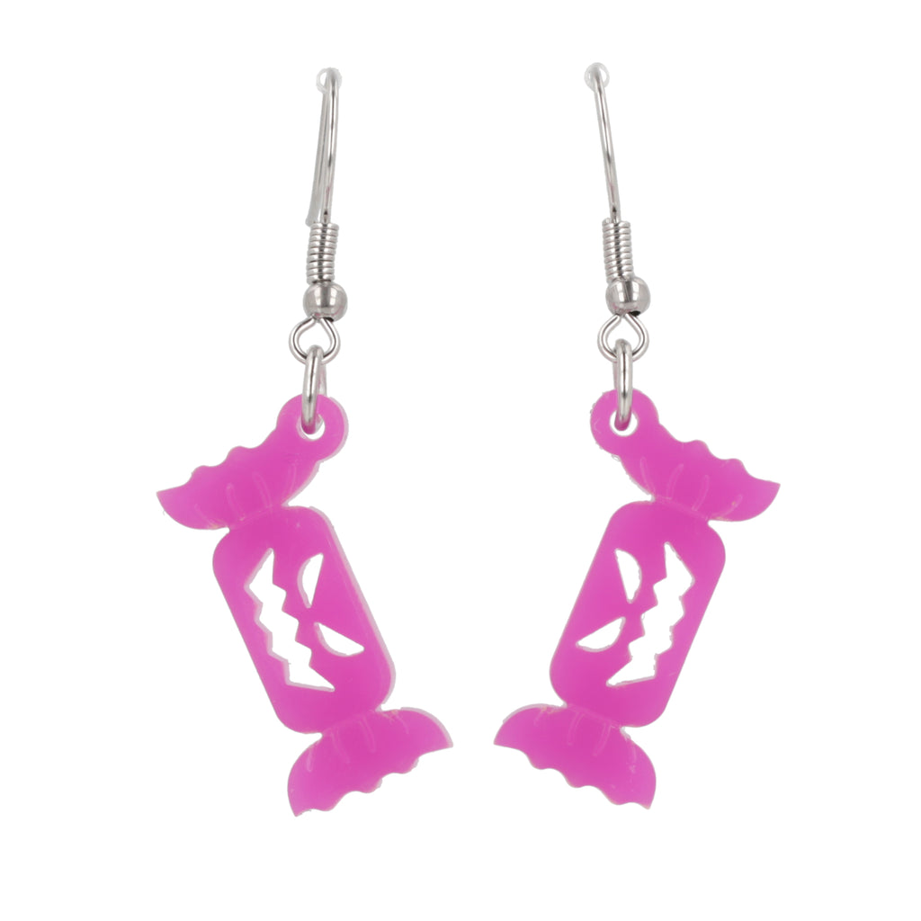 purple sweet wrapper charms with craved out faces on stainless steel earwires