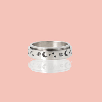 Titanium ring with a black sun, moon and stars design