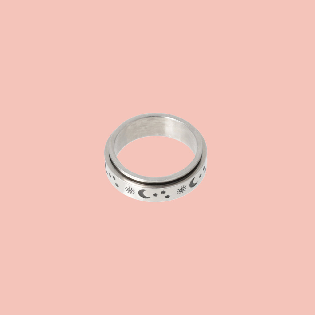 Titanium ring with a black sun, moon and stars design