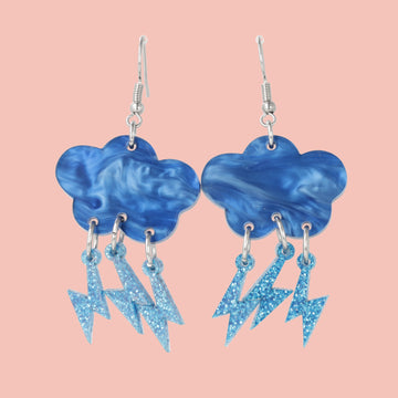 Blue marble clouds attached to blue glitter lightning bolt charms on stainless steel earwires