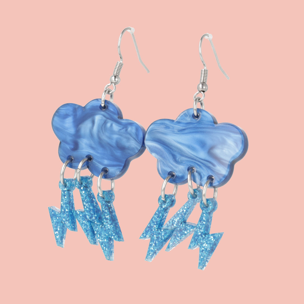 Blue marble clouds attached to blue glitter lightning bolt charms on stainless steel earwires