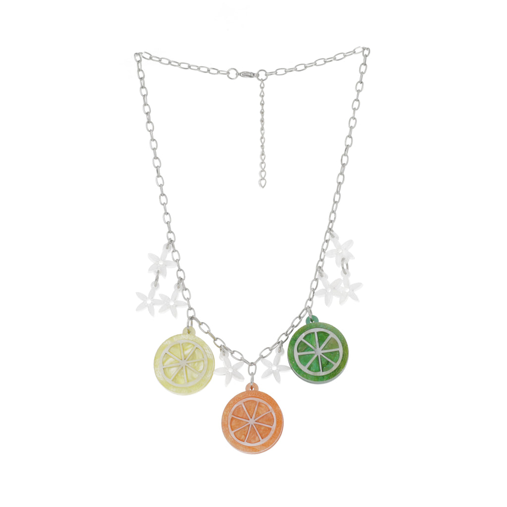 Lemon, orange and lime slice charms, three white flower charms either side of the lemon pendant and the lime pendant and two white flower charms one in between the lemon and orange cha  on a stainless steel chainm and one in between the orange and lime charm