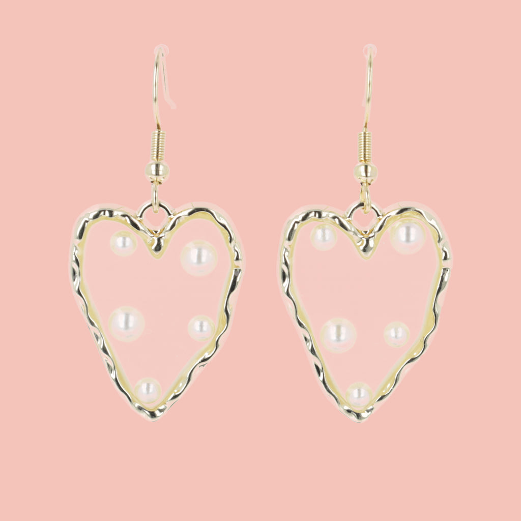  heart-shaped earrings featuring a stunning gold outline and a transparent middle filled with shimmering pearls