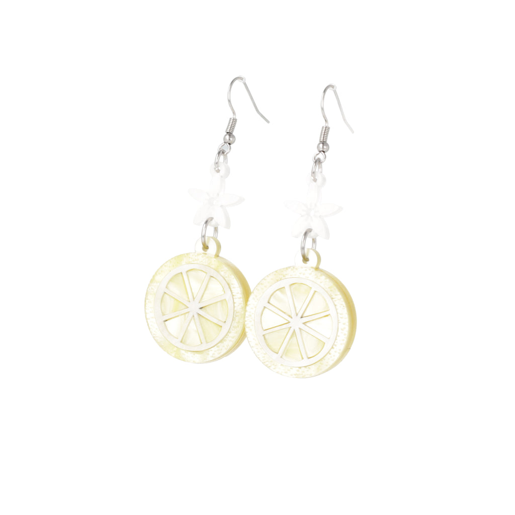 Lemon slice charms suspended fromn white flower charms on stainless steel earwires