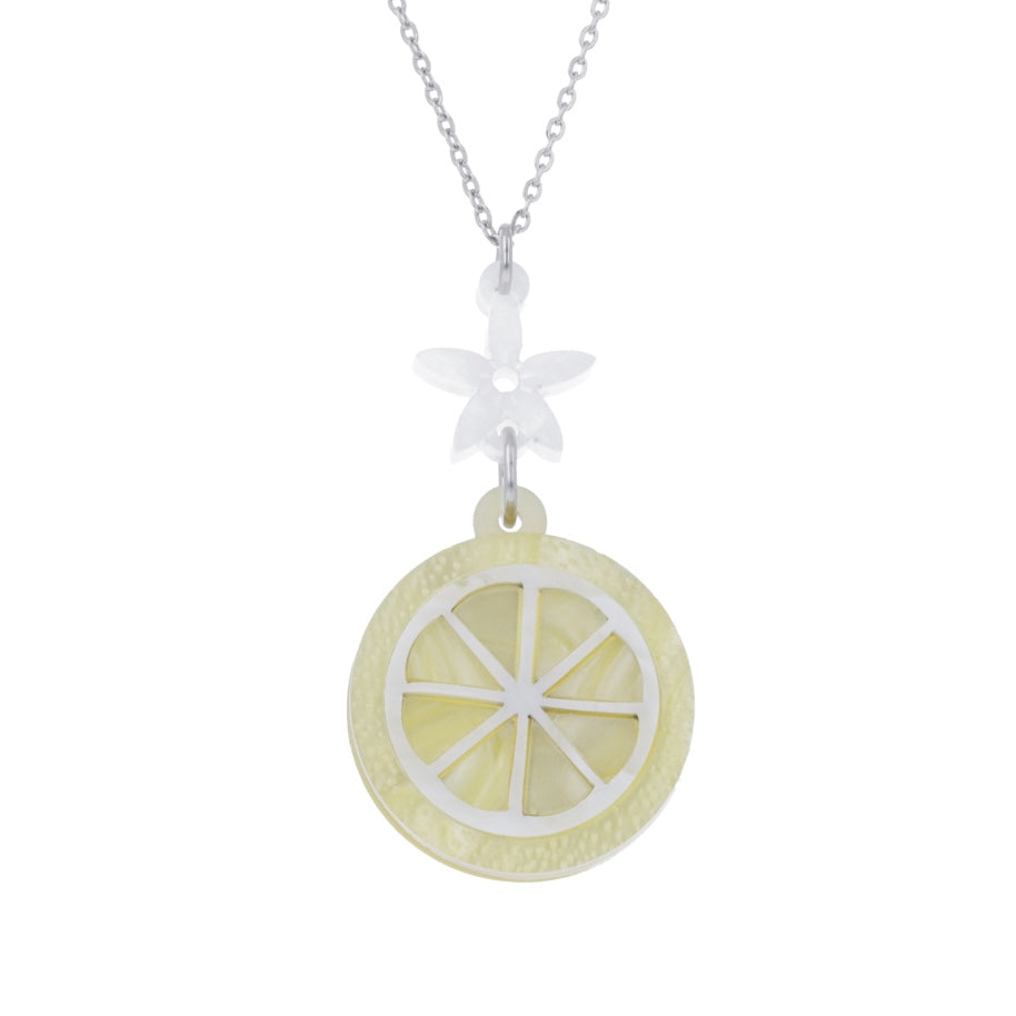 lemon slice pendant suspended from a white flower charm on a stainless steel chain