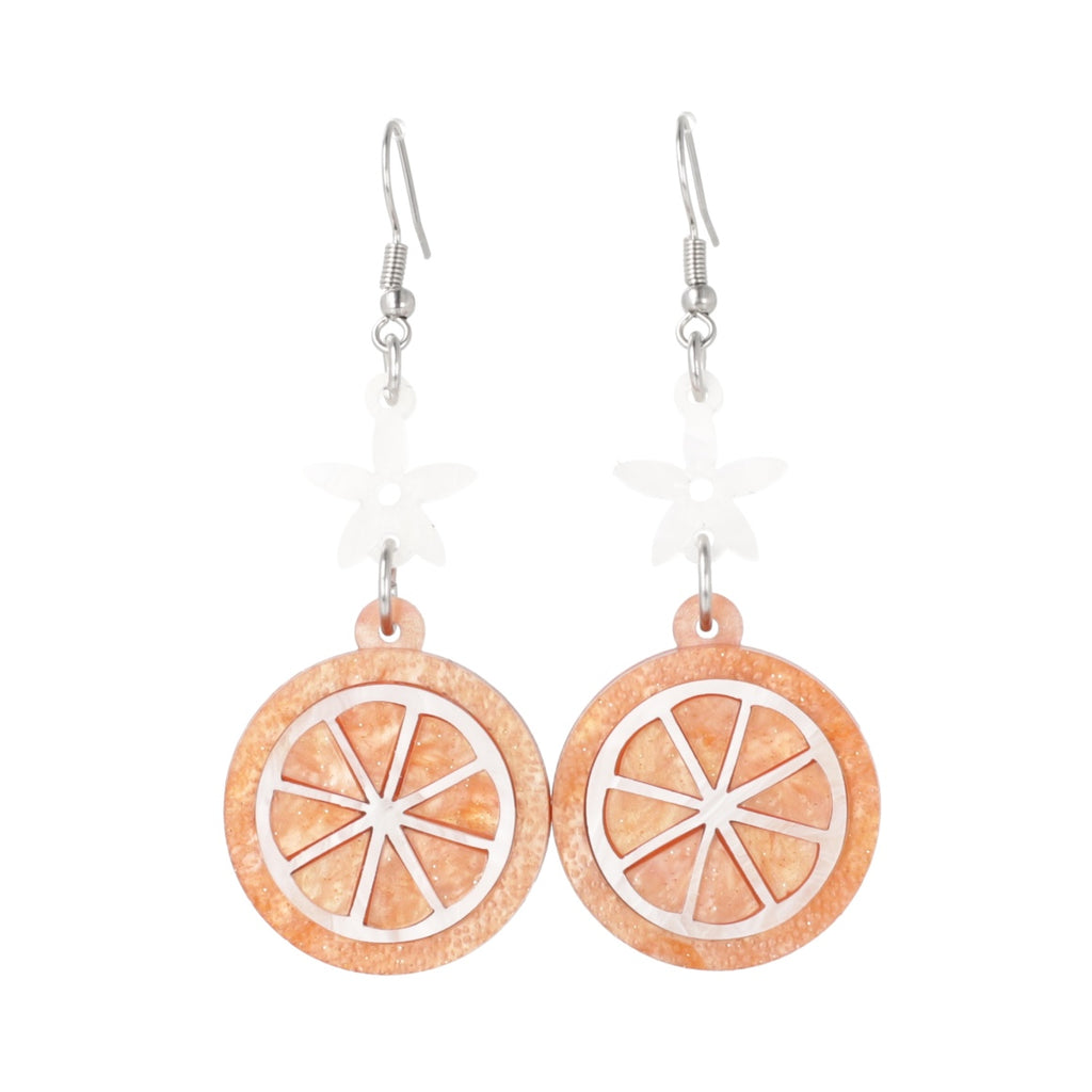 orange slice pendant suspended from white flower charms on stainless steel earwires