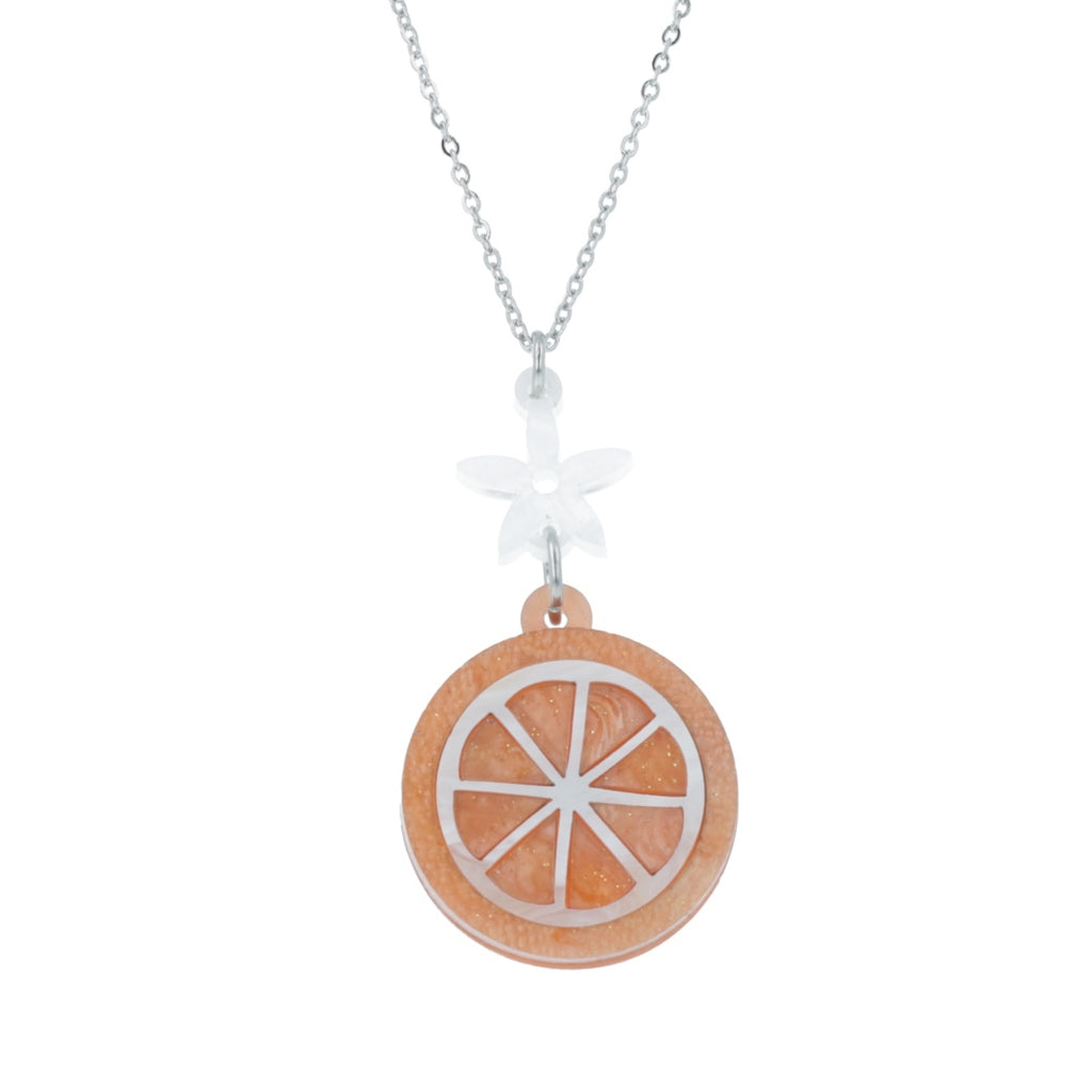 Orange slice pendant suspended from a white flower charm on a stainless steel chain