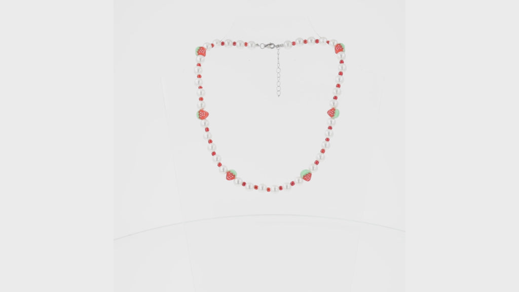 Faux pearl necklace featuring red beads and strawberry charms with a base metal clasp