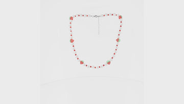 Faux pearl necklace featuring red beads and strawberry charms with a base metal clasp