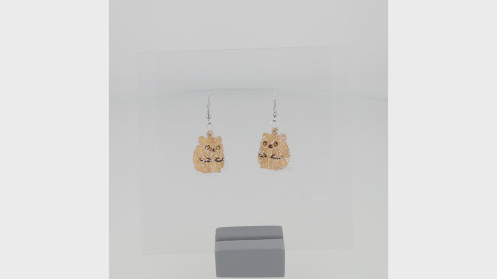 360 view of hamster charms with a layer of holographic glitter to replicate a ghost on stainless steel earwires