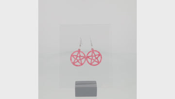 360 view of model wearing marble pink cut out pentacle charms on stainless steel earwires