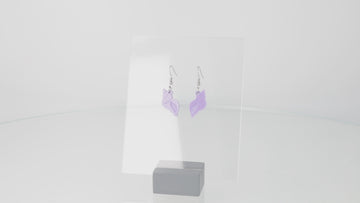 360 view of Lilac hermit shell charm on stainless steel earwires