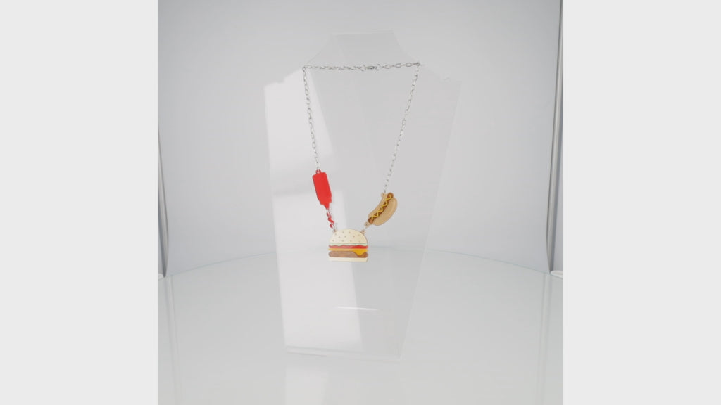 360 view of Stainless steel oval link chain with a kethup, cheeseburger and mustard hot dog pendant