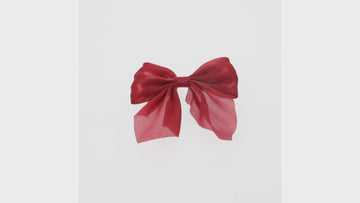 red shimmery hair bow with a base metal clip