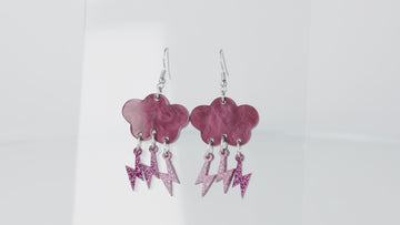 Deep purple marble clouds attached to purple glitter lightning bolt charms on stainless steel earwires