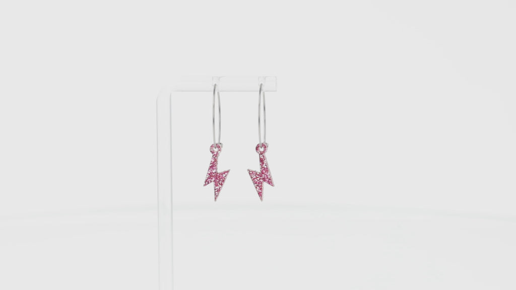 360 view of Mini Pink Glitter Lightning Bolt charms on stainless steel hoops