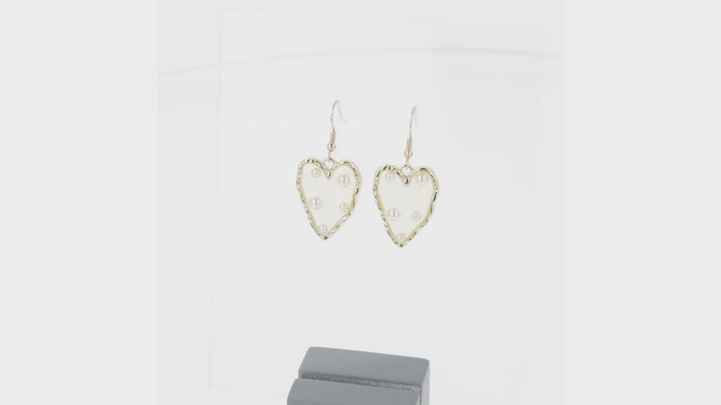 360 view of  heart-shaped earrings featuring a stunning gold outline and a transparent middle filled with shimmering pearls