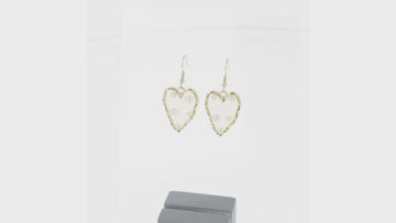 360 view of  heart-shaped earrings featuring a stunning gold outline and a transparent middle filled with shimmering pearls