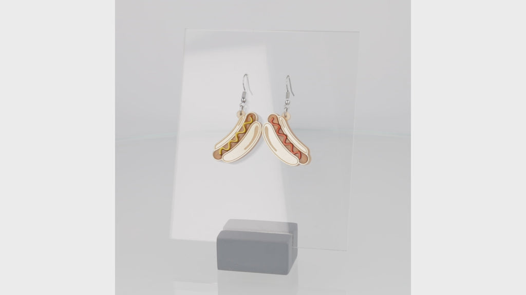 360 view of Hotdog charms (left with mustard and right with ketchup) on stainless steel earwires