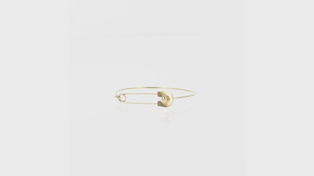 Gold plated stainless steel bangle witha safety pin fastening